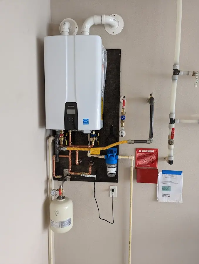 Professional plumber installing copper piping in a Turpin Hills home